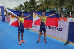 Hai vận động viên Fernando Tan Casares (phải) và Andrew Remonino của đội Philipines ăn mừng chiến thắng sau khi về đích. (Ảnh: Công Đạt/TTXVN)