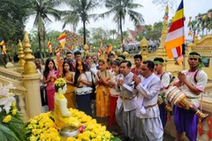 Nghi thức tắm tượng phật bằng nước ướp hương, gột rửa những điều không may mắn năm cũ để sang năm mới mọi sự được như ý. (Ảnh: Tuấn Đức/TTXVN) 