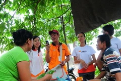 Cán bộ nhân viên Viettel tổ chức bán hàng tại một làng của Lào. (Ảnh: PV/Vietnam+)