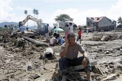 Cơn bão Washi khiến nhiều gia đình Philippines điêu đứng. (Ảnh: AP)