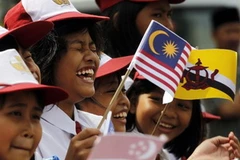 Niềm vui của các em học sinh khi đón chào các đoàn tham dự SEA Games 26. (Nguồn: Reuters)