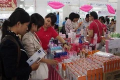 Khách tham quan chọn mua hàng tại gian trưng bày sản phẩm của doanh nghiệp Thái Lan. (Ảnh: Trần Lê Lâm/TTXVN)