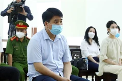 Bị cáo Nguyễn Đức Chung tại phiên tòa phúc thẩm vụ mua chế phẩm sinh học xử lý nước. (Ảnh: Phạm Kiên/TTXVN)