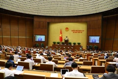 Bộ trưởng Bộ Công an Tô Lâm trình bày Tờ trình về dự thảo Nghị quyết về thí điểm mô hình tổ chức hoạt động lao động, hướng nghiệp, dạy nghề cho phạm nhân ngoài trại giam. (Ảnh: Văn Điệp/TTXVN)