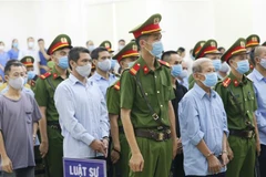 Các bị cáo nghe đại diện Viện Kiểm sát nhân dân thành phố Hà Nội đọc cáo trạng. (Ảnh: Doãn Tấn/TTXVN)