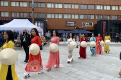 Trình diễn nón và áo dài truyền thống tại Festival du Vietnam 2021 ở trung tâm thị trấn La Plagne Tarentaise, miền Đông Nam nước Pháp hồi tháng 7/2021. (Ảnh: Thu Hà/TTXVN)
