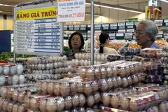 Người tiêu dùng mua sản phẩm bình ổn giá tại siêu thị Co.op Mart Nguyễn Đình Chiểu, TP.HCM. (Ảnh: Thanh Vũ/TTXVN)