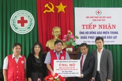 Đại diện Bộ Ngoại giao Việt Nam trao tiền và hiện vật của cộng đồng người Việt tại Mỹ ủng hộ tỉnh Phú Yên. (Ảnh: Xuân Triệu/TTXVN)