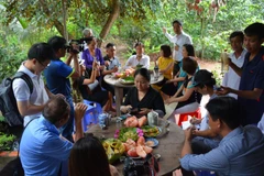 Khách du lịch thưởng thức các món ăn chế biến từ bưởi ở Cồn Hô. (Nguồn: dulichtravinh.com.vn)