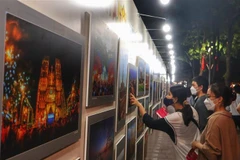 Người dân Thủ đô xem ảnh trưng bày tại một triển lãm. (Ảnh: Nguyễn Thuỳ Dương/TTXVN phát)