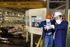 Chủ tịch nước Nguyễn Xuân Phúc thăm Công ty cổ phần Thép Hòa Phát Dung Quất tháng 2/2022. (Ảnh: Thống Nhất/TTXVN)