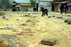 Người dân xã Nậm Loỏng vần đá hộc ra giữa đường ngăn ô tô đi chậm lại. (Ảnh: Công Hải/Vietnam+)