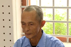 Đối tượng Nguyễn Hòa Bình tại cơ quan công an. (Ảnh: TTXVN)