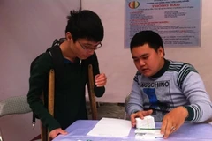Người khuyết tật được tư vấn việc làm. (Ảnh: Hồng Kiều/Vietnam+)