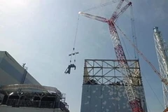 Cần cẩu đang nâng các bộ phận đầu tiên của vỏ bọc lò phản ứng số 1. (Nguồn: Internet)