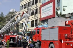 Lực lượng cứu hỏa làm nhiệm vụ tại hiện trường. (Ảnh: Mạnh Linh/TTXVN)