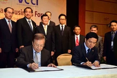 Lễ ý kết giữa HBC và UOA với sự chứng kiến của Chủ tịch nước Trương Tấn Sang. (Ảnh: Hoàng Tuấn/Vietnam+)