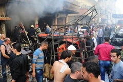 Hiện trường vụ nổ bom ở Jaramana. (Nguồn: AFP/TTXVN)