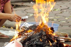 Hà Nội: Cảnh báo nguy cơ cháy nổ từ việc đốt vàng mã ngày Tết. (Ảnh: TTXVN phát)