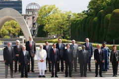 Thủ tướng Phạm Minh Chính cùng Trưởng đoàn các nước khách mời chụp ảnh chung trước Đài tưởng niệm Nạn nhân vụ nổ bom nguyên tử tại Công viên Tưởng niệm hòa bình Hiroshima. (Ảnh: Dương Giang/TTXVN)