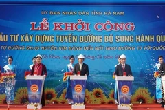 Các đại biểu bấm nút Khởi công Dự án đầu tư xây dựng tuyến đường bộ song hành Quốc lộ 21, tại xã Khả Phong, huyện Kim Bảng. (Ảnh: Thanh Tuấn/TTXVN)