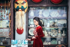 Áo dài nhung đỏ họa tiết trồng đồng của nhà thiết kế Nhật Dũng. (Ảnh: Luke Nguyễn)