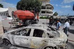Chiếc xe bị phá hủy tại trường học của Mỹ ở thủ đô Tunis, Tunisia ngày 14/9. (Ảnh: AFP/TTXVN)