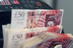 Giao dịch đồng bảng Anh tại Kuala Lumpur, Malaysia ngày 16/1. (Nguồn: AFP/TTXVN)