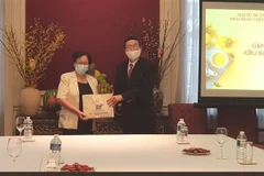 Đại sứ Vũ Anh Quang tặng quà bà con Việt kiều. (Ảnh: Kim Chung/TTXVN)