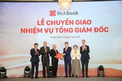 Ông Lê Quốc Long (thứ 4 tư phải sang) nhận nhiệm vụ mới từ Hội đồng quản trị SeABank. (Ảnh: PV/Vietnam+)