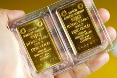 Giá vàng SJC nhảy nhót chóng mặt. (Ảnh: Vietnam+)