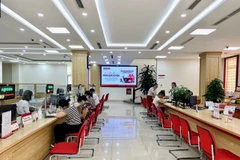 Giao dịch tại Agribank. (Ảnh: PV/Vietnam+)