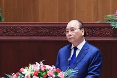 Chủ tịch nước Nguyễn Xuân Phúc phát biểu tại Kỳ họp lần thứ nhất, Quốc hội Lào khóa IX. (Ảnh: Thống Nhất/TTXVN)
