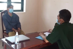 Lấy lời khai một nghi phạm buôn lậu thuốc lá. (nguồn: thanhnien)