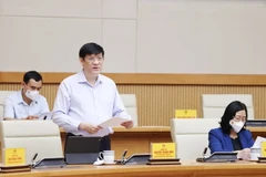 Bộ trưởng Bộ Y tế Nguyễn Thanh Long báo cáo công tác phòng, chống dịch. (Ảnh: Dương Giang/TTXVN)