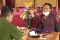 Đối tượng Lý A Đáp cũng tang vật tại cơ quan công an. (Ảnh: TTXVN phát)
