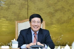 Phó Thủ tướng, Bộ trưởng Bộ Ngoại giao Phạm Bình Minh tại buổi điện đàm với Đặc phái viên Tổng thống Hoa Kỳ về biến đổi khí hậu John Kerry. (Ảnh: TTXVN)