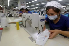 Sản xuất khẩu trang nano sử dụng nhiều lần tại TNG. (Ảnh: Trần Việt/TTXVN)