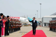 Cán bộ, nhân viên Đại sứ quán và đại diện cộng đồng người Việt Nam tại Lào cùng các quan chức Lào ra tiễn Chủ tịch nước Võ Văn Thưởng tại Sân bay quốc tế Wattay ở thủ đô Vientiane. (Ảnh: Thống Nhất/TTXVN)