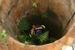 Lực lượng công an triển khai phương án cứu nạn người đàn ông bị rớt xuống giếng sâu. (Ảnh: TTXVN phát)