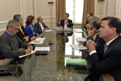 Tổng thống Juan Manuel Santos (giữa) trong cuộc gặp với Trưởng đoàn đàm phán của Chính phủ Colombia và Ủy viên cấp cao phụ trách về đàm phán hòa bình, ngày 21/10. (Nguồn: EPA/TTXVN)