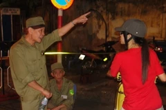 Lực lượng dân phòng đang hướng dẫn người dân không được vào các khu vực diễn ra lễ Tổng duyệt binh trước Đại lễ. (Ảnh: Mạnh Hùng/Vietnam+).