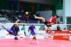 Pha cản phá cầu của vận động viên đội tuyển Việt Nam (áo đỏ) trong trận gặp Campuchia. (Ảnh: An Thành Đạt/TTXVN)