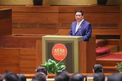 Thủ tướng Phạm Minh Chính trình bày Báo cáo Kết quả Thực hiện Kế hoạch Phát triển Kinh tế-Xã hội năm 2023; Dự kiến Kế hoạch Phát triển Kinh tế-Xã hội năm 2024. (Ảnh: Dương Giang/TTXVN)