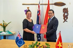 Đại sứ Việt Nam tại New Zealand Nguyễn Văn Trung và Cao ủy Quần đảo Cook tại New Zealand Elizabeth Wright-Koteka ký Thông cáo chung. (Ảnh: TTXVN phát) 