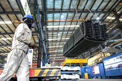 Công nhân chuyển vật liệu tại một nhà máy ở tỉnh Giang Tô, Trung Quốc, ngày 27/8/2021. (Ảnh: AFP/TTXVN) 