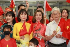 Chị Ngô Lê Thùy Trang, Chủ tịch Hội người Việt Nam ở tỉnh Fukushima (thứ hai từ phải sang), cổ vũ cho đoàn thể thao Việt Nam. (Ảnh: Đào Thanh Tùng/TTXVN) 