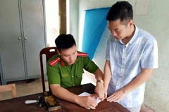 Đối tượng Hoàng Anh Tuấn tại cơ quan công an. (Nguồn: TTXVN phát) 