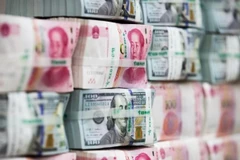 Đồng Nhân dân tệ và đồng USD. (Nguồn: Bloomberg) 