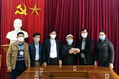 Cụ Đàm Điệt trao sổ tiết kiệm 100 triệu đồng ủng hộ quỹ phòng chống dịch COVID-19 xã Hưng Thông (Nghệ An). (Ảnh: TTXVN phát) 